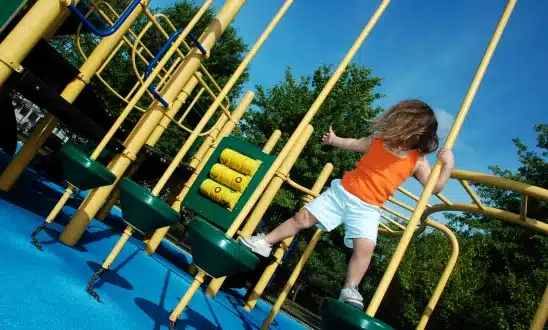 Child climbing on playground equipment